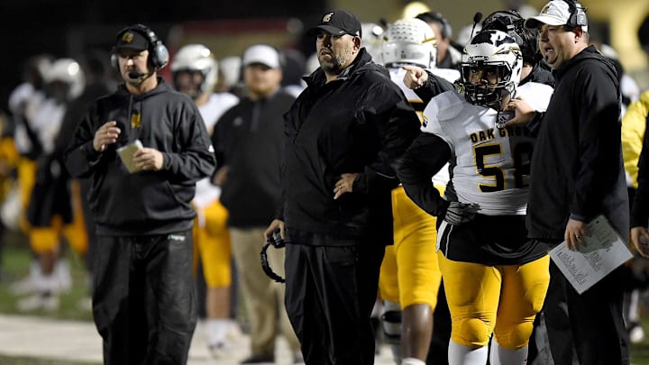 Oak Grove head coach Drew Causey (center) and his staff watch an extra point in the MHSAA Class 6A South State Championship on Friday, November 23, 2018, at Brandon High School in Brandon, Miss. 