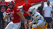 Jacksonville State quarterback Tyler Huff tries to evade the tackle of Southern Miss' Tre Pinkney during college football action at Burgess-Snow Field AmFirst Stadium in Jacksonville, Alabama September 21, 2024. (Dave Hyatt / Special to the Gadsden Times)