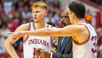 Indiana's Luke Goode (10) and Trey Galloway (32) talk with Coach Mike Woodson during the Indiana versus Purdue mens basketball game at Simon Skjodt Assembly Hall on Sunday, Feb. 23, 2025.