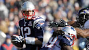 New England Patriots quarterback Tom Brady tries to evade Baltimore Ravens linebacker Ray Lewis.