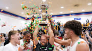 Columbus head coach Andrew Moran proudly hoists the trophy surrounded by his player after winning the 2025 Chipotle Nationals championship in Indiana.