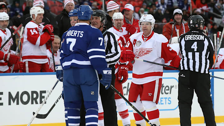 Dec 31, 2016; Toronto, ON, Canada; Detroit Red Wings forward Kris Draper (33) exchanges heated words with Toronto Maple Leafs forward Gary Roberts (7) in the third period during the 2017 Rogers NHL Centennial Classic Alumni Game at BMO Field. The Red Wings beat the Maple Leafs 4-3. Mandatory Credit: Tom Szczerbowski-Imagn Images