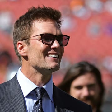 NFL legend Tom Brady is all smiles before an NFL football game at Huntington Bank Field, Sunday, Sept. 8, 2024, in Cleveland, Ohio.