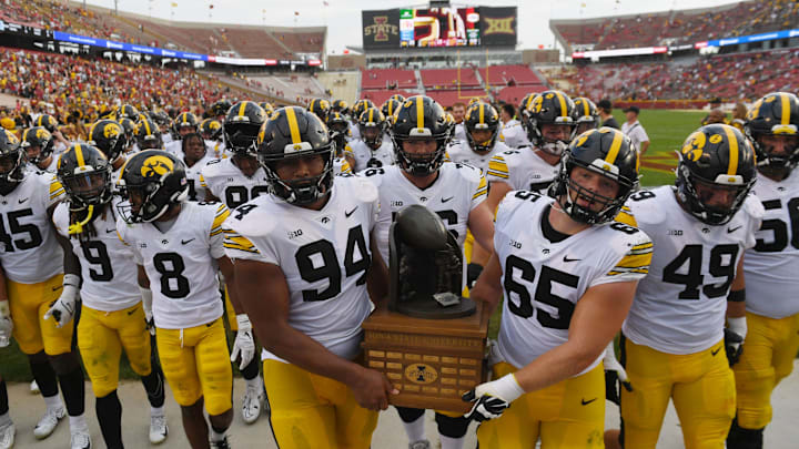 Iowa Football team celebrates with Cy-Hawk trophy after winning 20-13 over Iowa State at the Jack Trice Stadium on Saturday, Sept. 9, 2023, in Ames, Iowa.