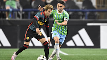 LA Galaxy midfielder Riqui Puig (10) controls the ball during the second half against Seattle Sounders FC midfielder Cristian Roldan (7) at Lumen Field