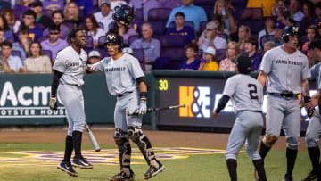 Alan Espinal celebrates with RJ Austin 42 after a home run as the LSU Tigers take on the Vanderbilt