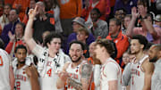 Clemson players, from left, Clemson guard Dillon Hunter (2), senior forward Ian Schieffelin (4), guard Jaeden Zackery (11) , guard Matt Kelly (20), and guard Chase Hunter (1) join in the alma mater song after Clemson beat North Carolina 85-65 Monday, Feb 10, 2025; Clemson, South Carolina, USA; at Littlejohn Coliseum.