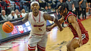 Jax StateÕs Jaron Pierre Jr. drives to the basket as New Mexico StateÕs Jaden Harris defends during college basketball action in Jacksonville, Alabama February 20, 2025. Jax State fell to New Mexico State 61-52. (Dave Hyatt / Hyatt Media LLC)