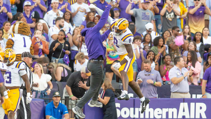 LSU WR Malik Nabers 8 celebrates with Receivers Coach Cortez Hankton after a touchdown as the LSU Tigers take on the Auburn Tigers at Tiger Stadium in Baton Rouge, Louisiana, Saturday, Oct. 14, 2023.