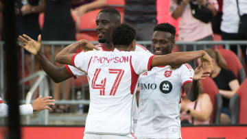 Derrick Etienne Jr. #11 (R) celebrates after scoring a goal...