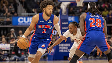 Detroit Pistons guard Cade Cunningham (2) moves the ball up court as center Isaiah Stewart (28) sets a pick on Cleveland Cavaliers guard Darius Garland (10) during the first half at Little Caesars Arena.