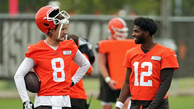 Cleveland Browns quarterback Kenny Pickett, left, chats with quarterback Shedeur Sanders (12) during an NFL practice at the C