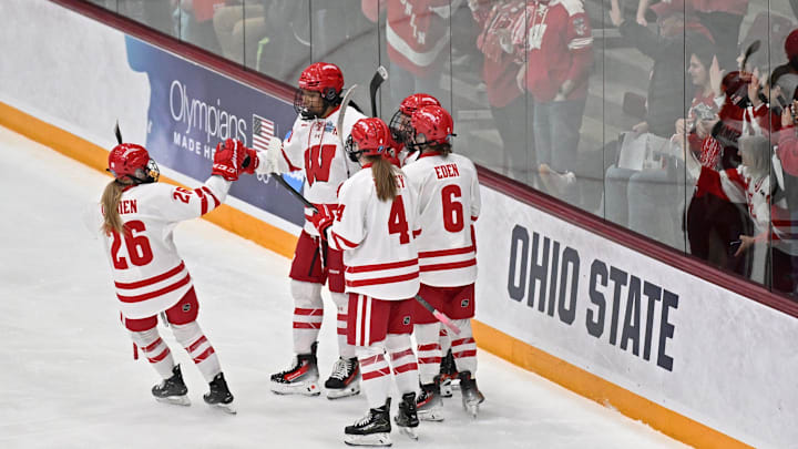 Wisconsin teammates mob right wing Laila Edwards (10) after her goal in the first period of the women's hockey Frozen Four national championship game Sunday, March 23, 2025, at Ridder Arena in Minneapolis, Minnesota. Wisconsin teammates mob right wing Laila Edwards (10) after her goal in the first period of the women's hockey Frozen Four national championship game Sunday, March 23, 2025, at Ridder Arena in Minneapolis, Minnesota.