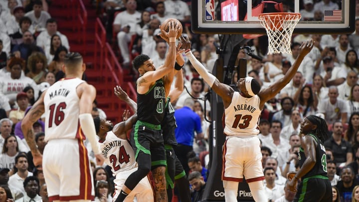 Apr 29, 2024; Miami, Florida, USA; Boston Celtics forward Jayson Tatum (0) takes a rebound away from Miami Heat center Bam Adebayo (13) during the second quarter of game four of the first round for the 2024 NBA playoffs at Kaseya Center. Mandatory Credit: Michael Laughlin-USA TODAY Sports