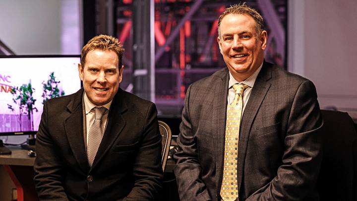 RALEIGH, NC - MARCH 12: TV personalities Tripp Tracy and Mike Maniscalco of the Carolina Hurricanes prepare for a broadcast prior to an NHL game against the Philadelphia Flyers on March 12, 2022 at PNC Arena in Raleigh, North Carolina. (Photo by Gregg Forwerck/NHLI via Getty Images)