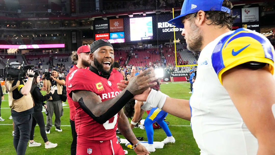 Former Husky Budda Baker greets Los Angeles Rams quarterback Matthew Stafford after their recent game. 