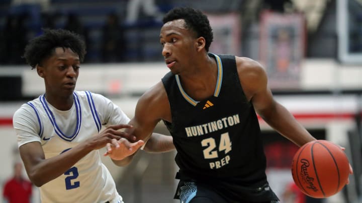 Huntington Prep gaurd Darryn Peterson, right, drives to the basket against Richmond Heights guard Demaris Winters Jr. during the first half of a basketball game in the Canton Play-By-Play Classic at Canton Memorial Field House, Saturday, Feb. 17, 2024, in Canton, Ohio.