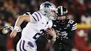 Kansas State Wildcats quarterback Avery Johnson (2) runs with the ball around Iowa State Cyclones linebacker Will McLaughlin (23) during the first quarter in the NCAA football at Jack Trice Stadium on Saturday, Nov. 30, 2024, in Ames, Iowa.