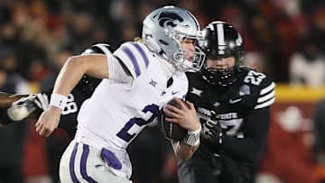 Kansas State Wildcats quarterback Avery Johnson (2) runs with the ball around Iowa State Cyclones linebacker Will McLaughlin (23) during the first quarter in the NCAA football at Jack Trice Stadium on Saturday, Nov. 30, 2024, in Ames, Iowa.