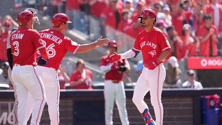 Jul 1, 2025: Toronto Blue Jays second baseman Andre Gimenez (0) hits a three run home run and celebrates with left fielder Davis Schneider (36) and centre fielder Myles Straw (3) against the New York Yankees during the fourth inning at Rogers Centre.