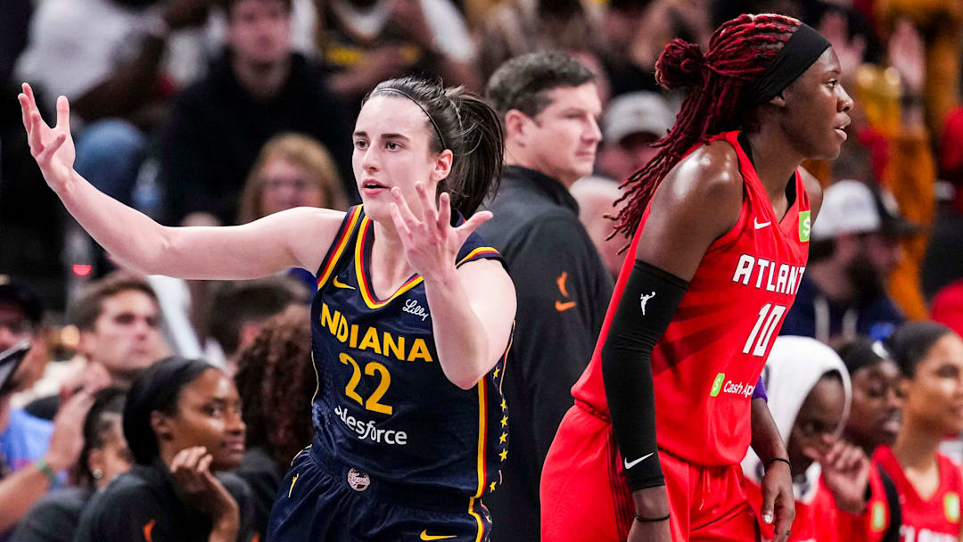 Indiana Fever guard Caitlin Clark (22) reacts after scoring a 3-pointer against Atlanta Dream guard Rhyne Howard (10) on Tuesday, May 20, 2025, during a game between the Indiana Fever and the Atlanta Dream at Gainbridge Fieldhouse in Indianapolis.