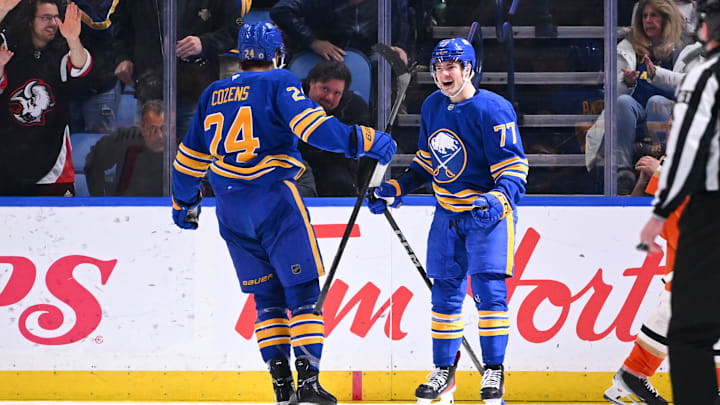 Dylan Cozens (74) and JJ Peterka (77) celebrating a goal against the Anaheim Ducks. 