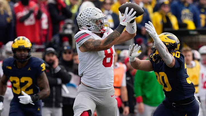 Nov 25, 2023; Ann Arbor, Michigan, USA; Ohio State Buckeyes tight end Cade Stover (8) catches a pass over Michigan Wolverines linebacker Jimmy Rolder (30) during the first half of the NCAA football game at Michigan Stadium.