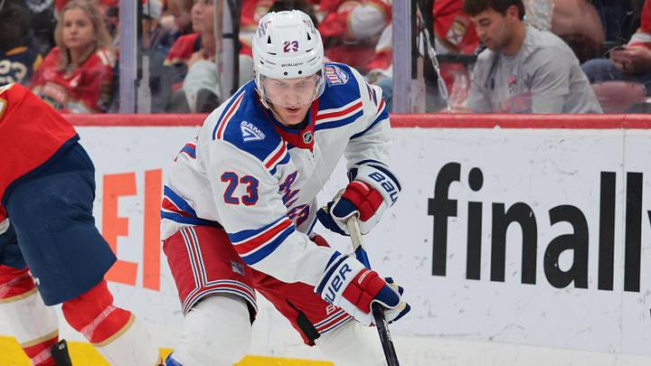 Apr 13, 2026; Sunrise, Florida, USA; New York Rangers defenseman Adam Fox (23) moves the puck against the Florida Panthers during the third period at Amerant Bank Arena.