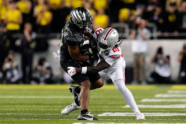 Ohio State Buckeyes cornerback Denzel Burke (10) makes a tackle on Oregon Ducks wide receiver