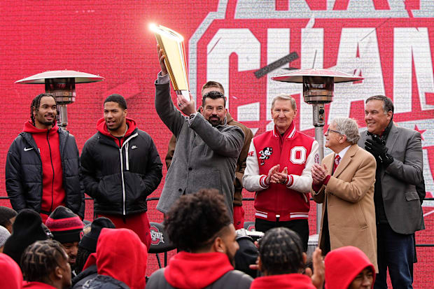 Ohio State Buckeyes head coach Ryan Day hoists the championship trophy.