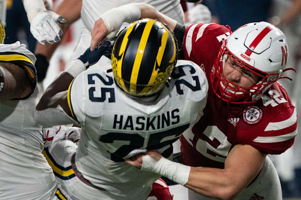 Nick Henrich makes a tackle against Michigan in 2021.