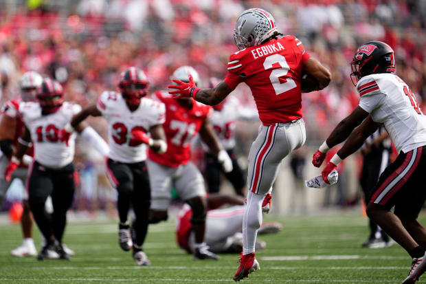 Wide receiver catches pass and starts to turn up field.