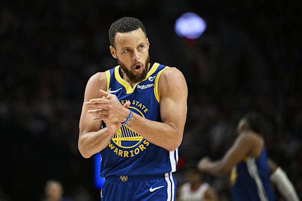 Golden State Warriors guard Stephen Curry claps his hands during a 2023-24 season game against the Portland Trail Blazers.