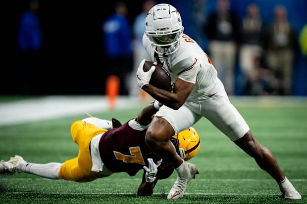 Texas Longhorns wide receiver Matthew Golden evades a tackle from Arizona State Sun Devils defensive back Shamari Simmons