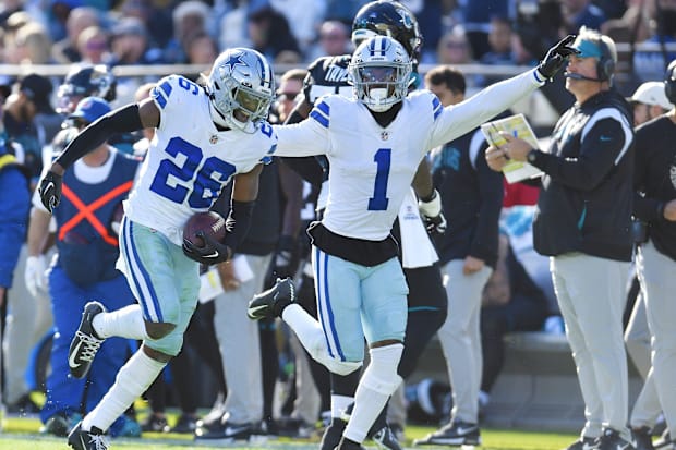 Dallas Cowboys cornerback DaRon Bland and cornerback Kelvin Joseph run down the sidelines after Bland intercepted a pass
