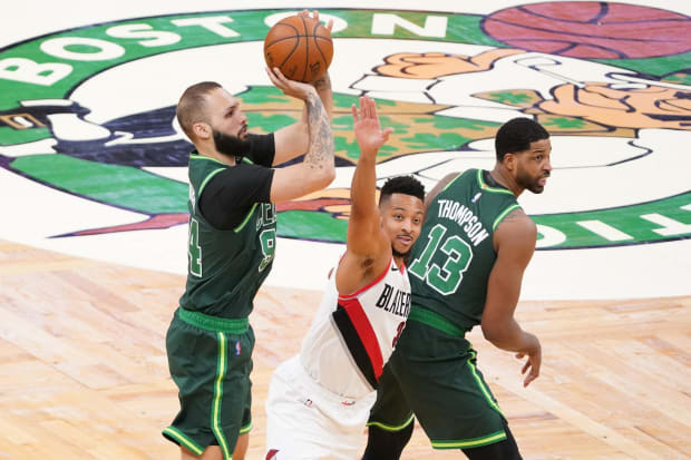 Boston Celtics guard Evan Fournier (94) shoots for three points against Portland Trail Blazers guard CJ McCollum (3).