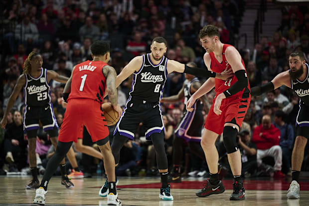 Sacramento Kings guard Zach LaVine (8) holds back Portland Trail Blazers center Donovan Clingan (23)