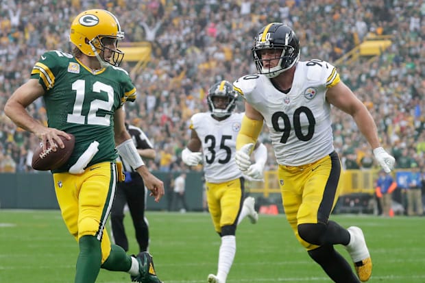 Green Bay Packers quarterback Aaron Rodgers scrambles for a touchdown against T.J. Watt on Oct. 3, 2021, at Lambeau Field.
