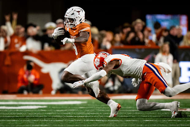 Longhorns running back Jerrick Gibson evades a tackle from Tigers safety R.J. Mickens.