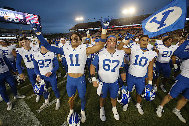 BYU football team celebrates after winning 41-27 over Iowa State.
