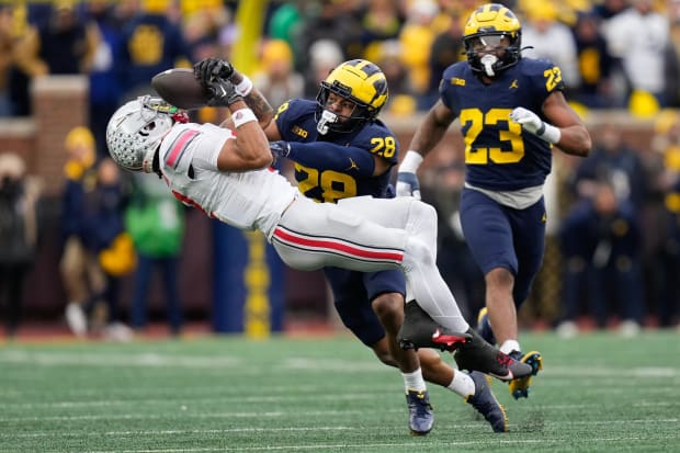 Michigan Wolverines safety Quinten Johnson hits Ohio State Buckeyes wide receiver Emeka Egbuka, forcing an incomplete pass