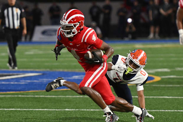 Mater Dei’s Kayden Dixon-Wyatt catches a pass and eludes a Bishop Gorman defender on Friday, September 6, 2024.