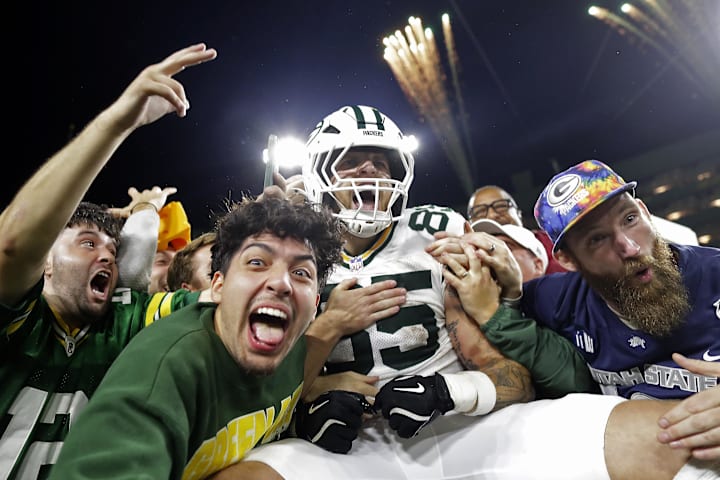 Green Bay Packers tight end Tucker Kraft celebrates a touchdown with fans against the Washington Commanders.