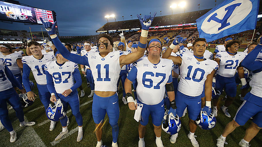 BYU football team celebrates after winning 41-27 over Iowa State.