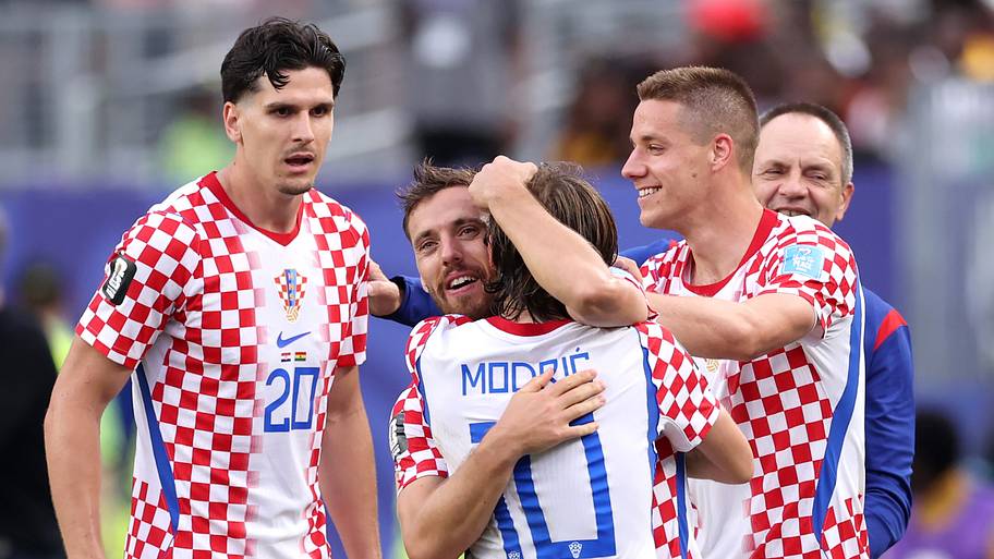 Luka Modrić (center) getting hugged.