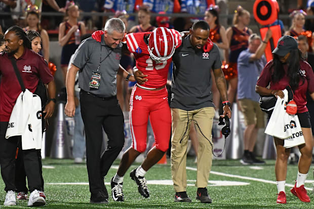 Mater Dei junior Chris Henry Jr. is helped off the field against Bishop Gorman after suffering from a leg injury on Friday, S