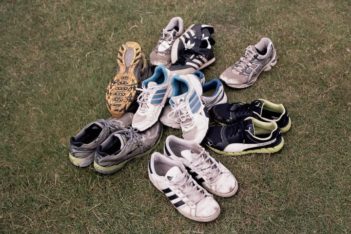 pile of shoes on grass
