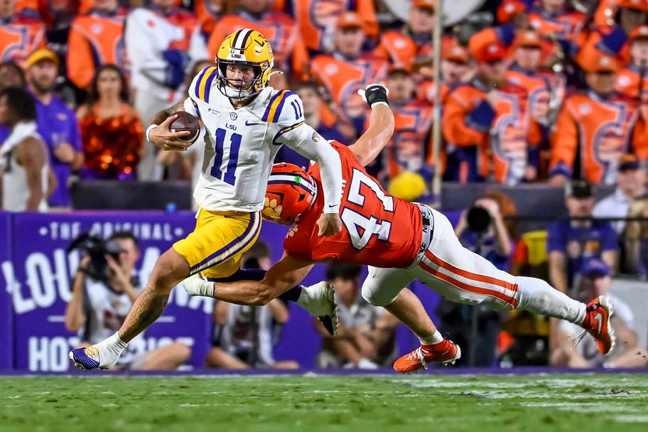 LSU backup quarterback Landen Clark runs away from a Clemson defender who’s trying to tackle him. 