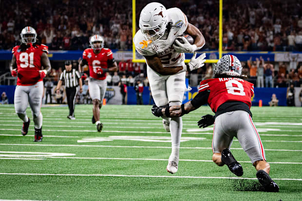 Texas Longhorns running back Jaydon Blue runs around Ohio State Buckeyes safety Lathan Ransom to score a touchdown.