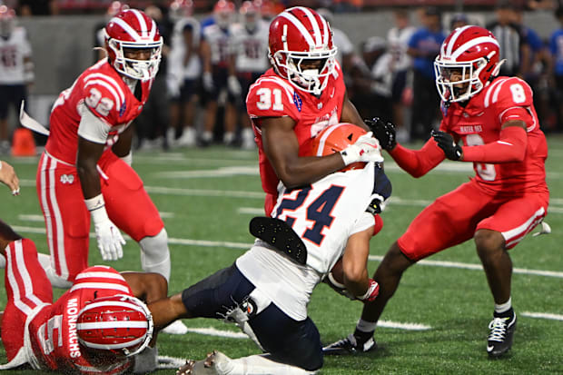 Mater Dei defense swarms the Bishop Gorman ball carrier on Friday, Sept. 6, 2024.